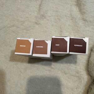 Set of Four Milk Makeup foundation sticks in Medium, Caramel, Deep, Espresso.